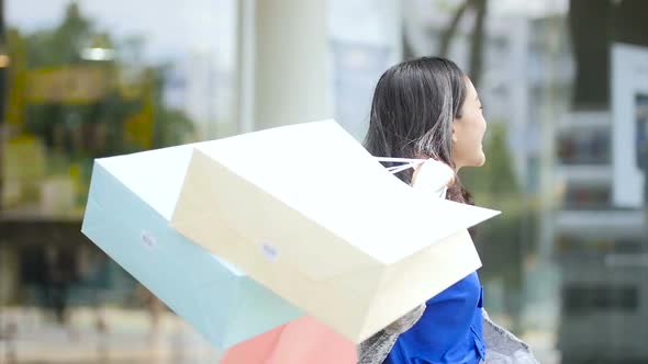 Happy woman holding shopping bags