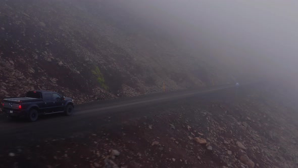 Pick-up Truck Drive Into Mountain Roads During Foggy Morning In Westfjords, Iceland. - Tracking Shot