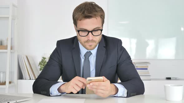 Businessman Reading Email on Smartphone Chat