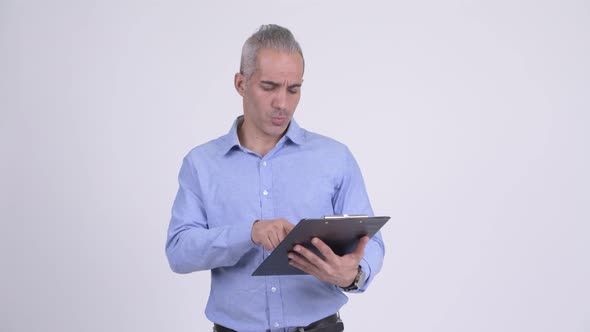 Happy Persian Businessman Showing Clipboard and Giving Thumbs Up