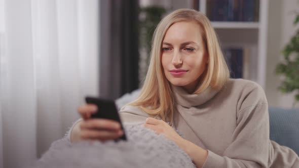 Woman Using Mobile at Home