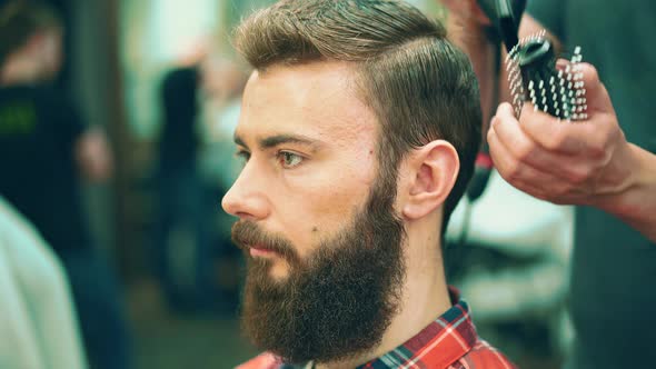 Young hipster in the barbershop