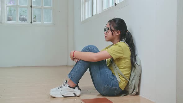 Asian Kid Girl Sitting Alone With Sad Feeling At School. Bullying, Discrimination And Racism