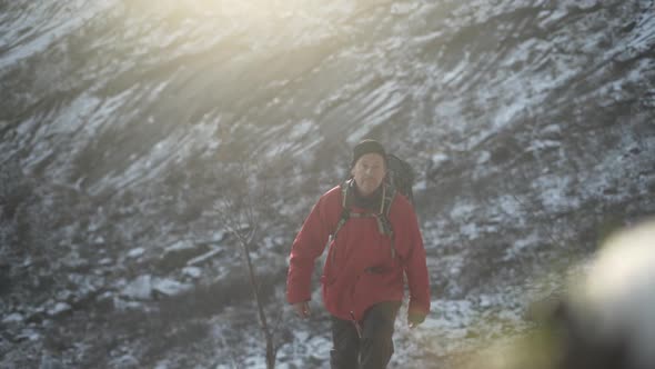 Hiker Walking Up Snowy Mountain Foothill