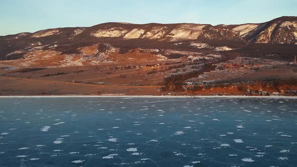 Aerial Perspective View of Beautiful Deep Blue Ice Textured Frozen Baikal Lake Surface and Coast