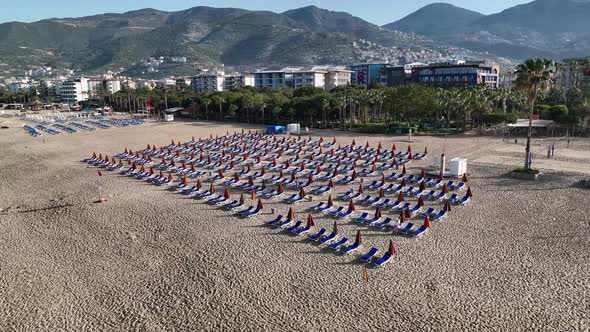 Empty sun loungers on the beach aerial view 4 K Turkey Alanya