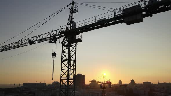 Construction Crane on a Construction Site in the City at Sunrise. Kyiv, Ukraine. Aerial View