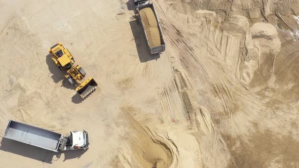 Aerial view loading bulldozer in open air quarry. Sand mining industry. Bulldozer machine. Crawler b