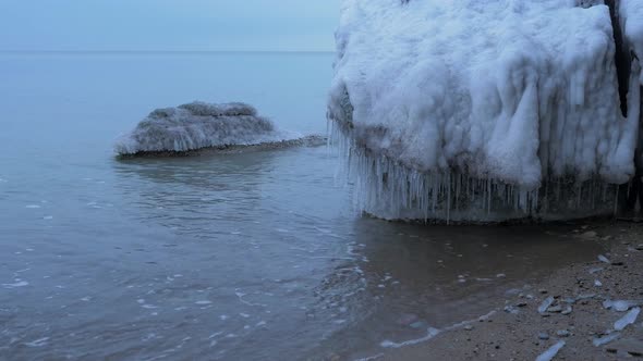 Small waves breaking against the ruins of Karosta Northern Forts fortification on the shore of Balti