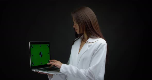 Asian Woman Send Email on Laptop with Chroma Key Isolated on Black Background