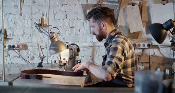 Craftsman Using Sewing Machine in Workshop