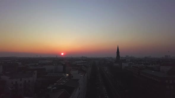 AERIAL: Over Berlin City Train Tracks with Sunset