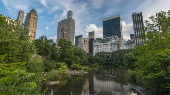 POV Timelapse shows People enjoy the Pond at Central Park in a sunny afternoon