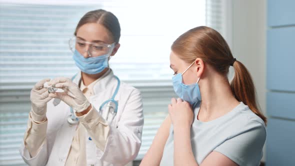 Blonde medical nurse in disposable face mask