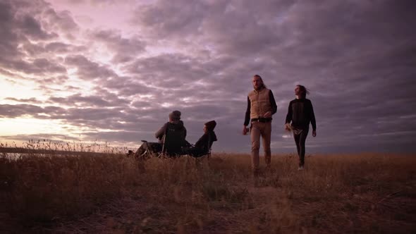 Friends Camping Walking to Find Wood Light a Fire