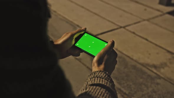 Shot of Vertical Shot Hand Man Holding a Mobile Telephone with Green Screen Background Electric