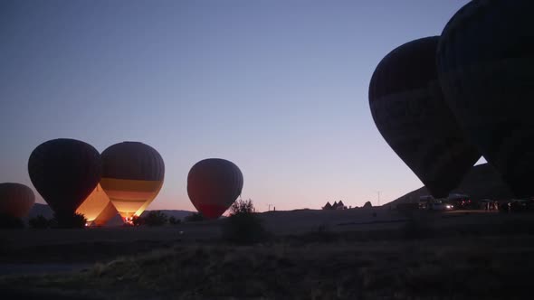 Hot air balloons take off from the fields around Goreme, Cappadocia, at sunrise