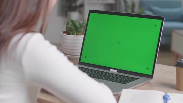 Close Up Hands Waving During Video Call On Laptop Computer With Green Screen Display At Home