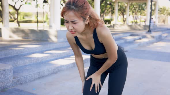 Woman Suffering From Knee Pain While Running