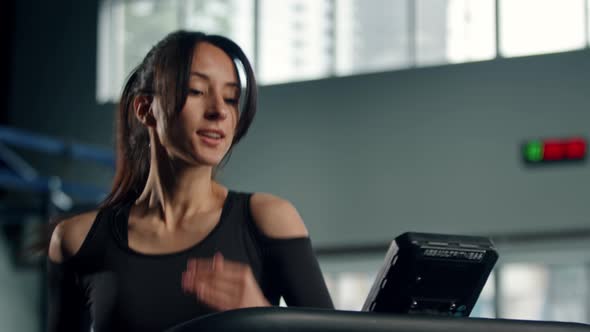 Woman athlete athlete is engaged in cardio training on the treadmill, thin beautiful sports girl