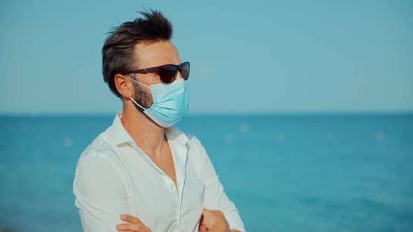 Face Mask Coronavirus On Vacation Holiday Lockdawn.Man In Face Mask At Covid Looking On Sea