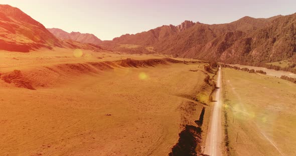 Aerial Rural Mountain Road and Meadow at Sunny Summer Morning