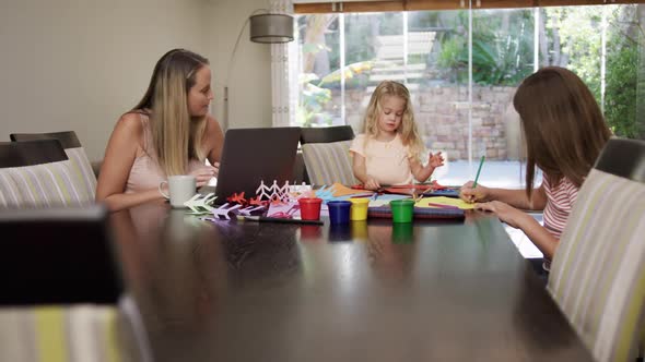 Mother and daughters painting together