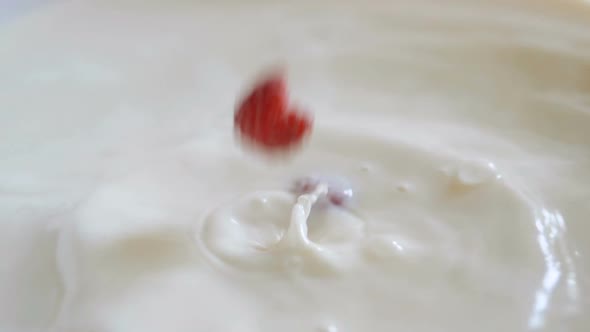 Raspberry Falls in a Bowl of Milk in Slow Motion