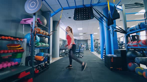 Beautiful woman working out in gym. Healthy young athletes woman doing exercises at gym