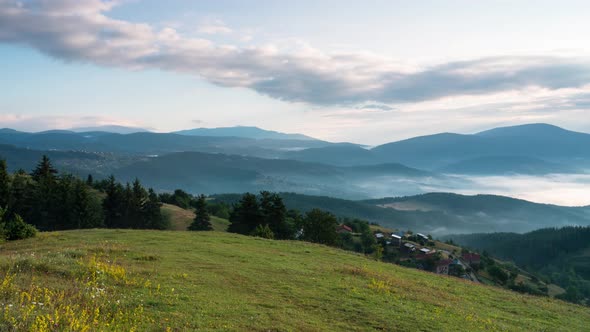 Fast-moving morning mists over the tree-covered mountain slopes