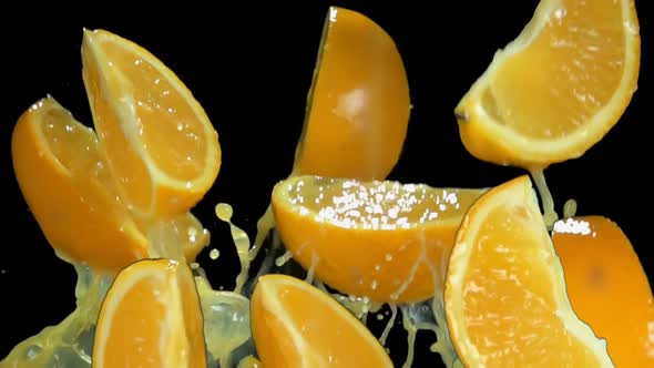Juicy Slices of Orange are Bouncing on the Black Background