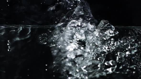 Slow Motion Water Surface Texture Splash Waves and Ripples on Black Background