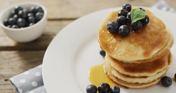 Video of pancakes on plate seen from above on white background