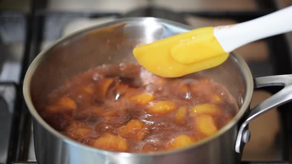 Plums boil in syrup during the preparation of plum jam