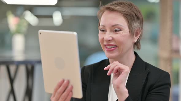 Video Call By Old Businesswoman on Tablet 