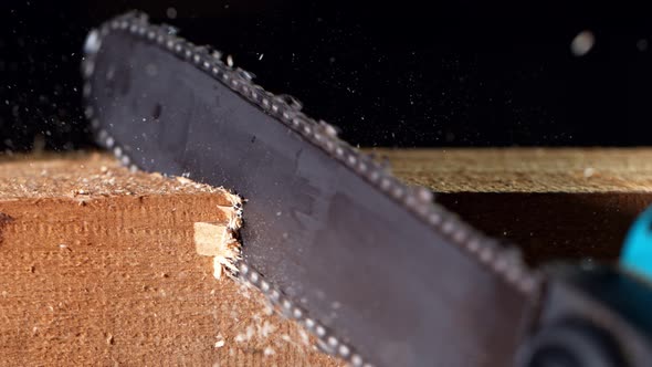 Super Slow Motion Detail Shot of Cutting Wood with Chainsaw at 1000 Fps