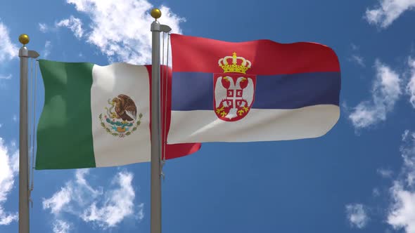 Mexico Flag Vs Serbia Flag On Flagpole