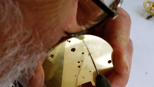 Horologist repairing a pocket watch