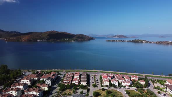 Aerial View of Fethiye City Located on the Coast of the Sea with Mountains and Spit on Background