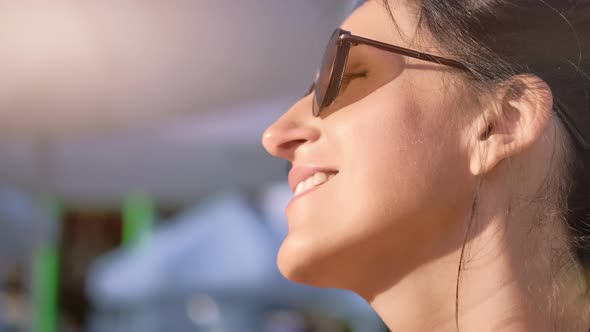 Closeup Pleasant Face of Beauty Sunny Woman Laughing Surrounded By Natural Sunlight Outdoor