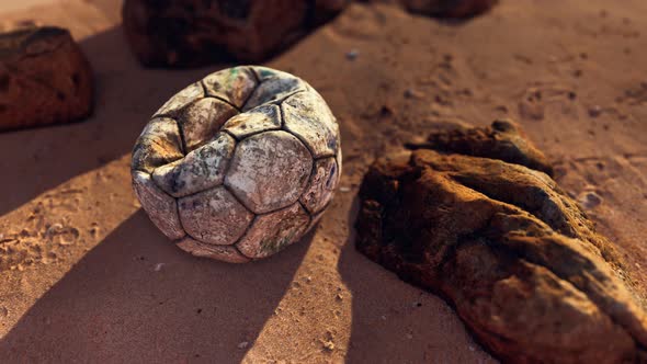 Old Leather Soccer Ball Abandoned on Sand