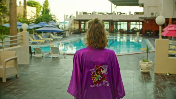 a Young Woman in a Vintage Bathrobe Goes to the Hotel Pool