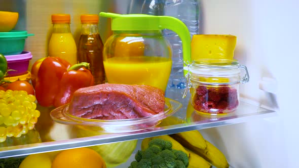 Fresh Raw Meat on a Shelf Open Refrigerator