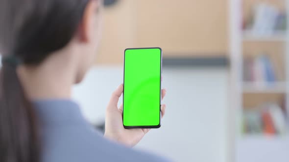 Latin Woman Using Smartphone with Green Chroma Key Screen