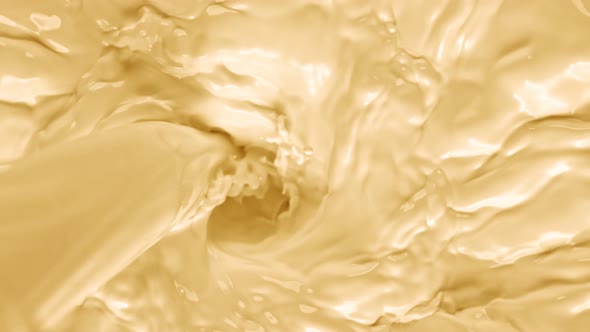 Super Slow Motion Shot of Pouring Yellow Milk Into Wortex at 1000Fps.