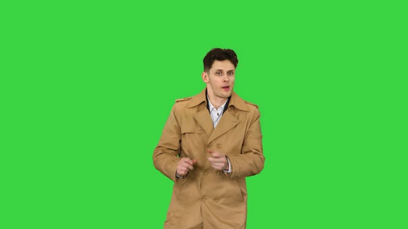 Young Man Wearing Trench Coat Dancing and Having Fun on a Green Screen, Chroma Key