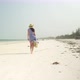 Young Woman Walks Barefoot On Beach Along Ocean - VideoHive Item for Sale