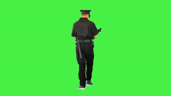Caucasian Policeman Walks Gets the Gun Out Reloads and Puts It Back on a Green Screen Chroma Key