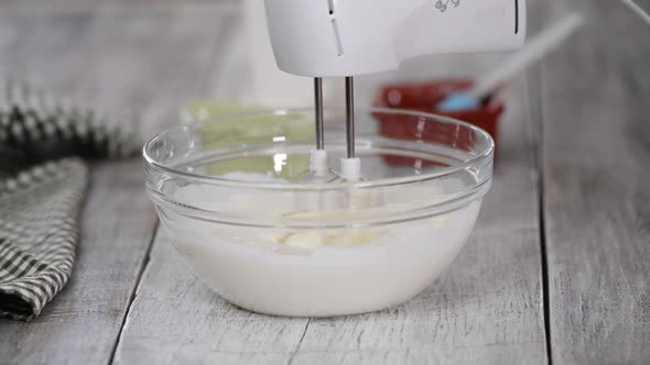 Electric Mixer Whipping Cream in Mixing Bowl, Making Cream Dessert