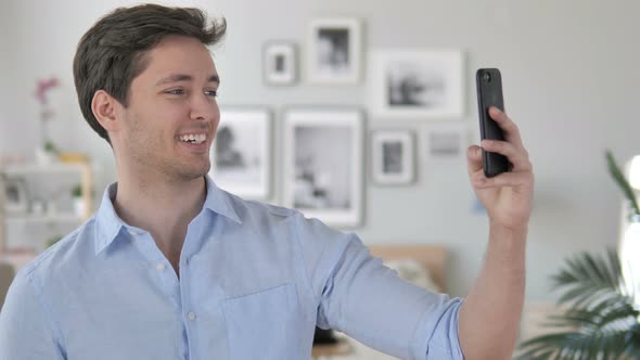 Handsome Young Man Taking Selfie on Smartphone